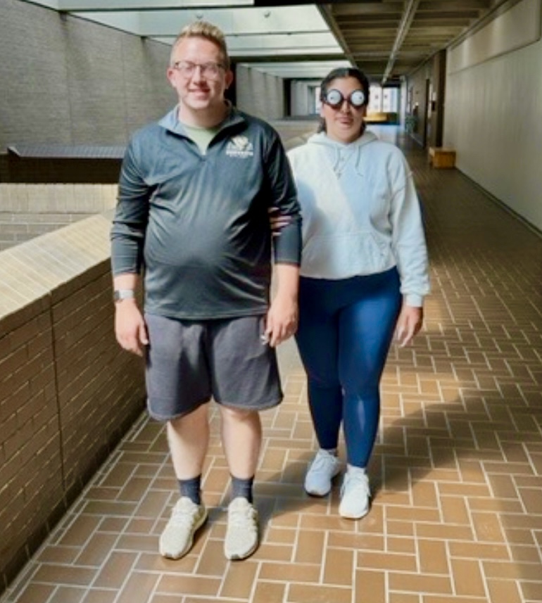 Students learning human guide with LVSK goggles